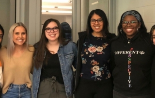 Six female KansasCOM students pose for a photo.
