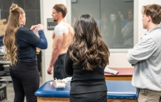 KHSC - KansasCOM medical students look on as the Witchita Thunder's athletic trainer works with a hockey player.