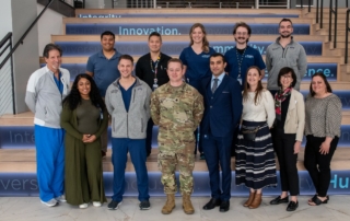 A group of KansasCOM students pose in a group photo with Lt Col Mike Zeola, MD.