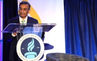 Dasa Gangadhar, MD, speak from behind a podium.
