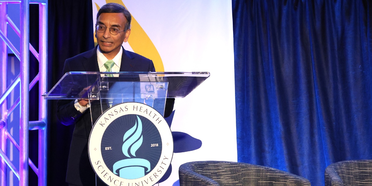 Dasa Gangadhar, MD, speak from behind a podium.