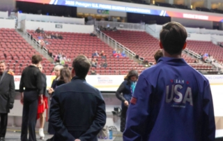People stand around an ice rink at the US Figure Skating Championships in 2025.