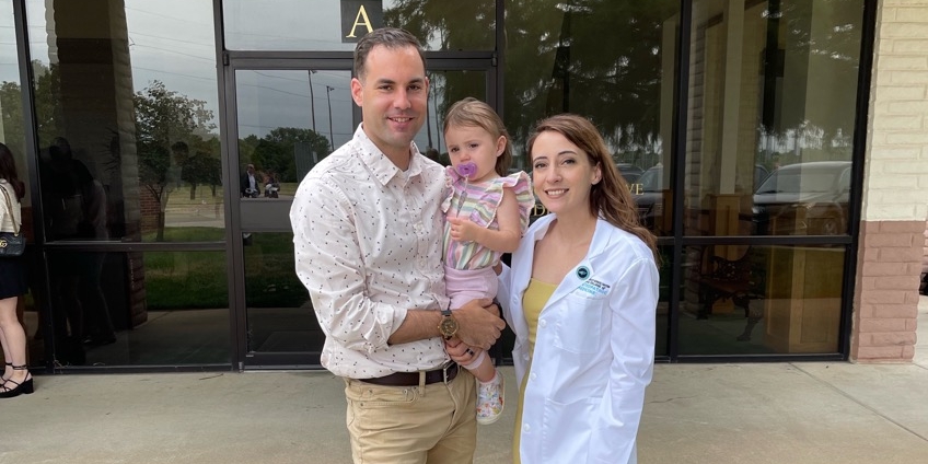 Kelsey Schmittling with her husband and child.