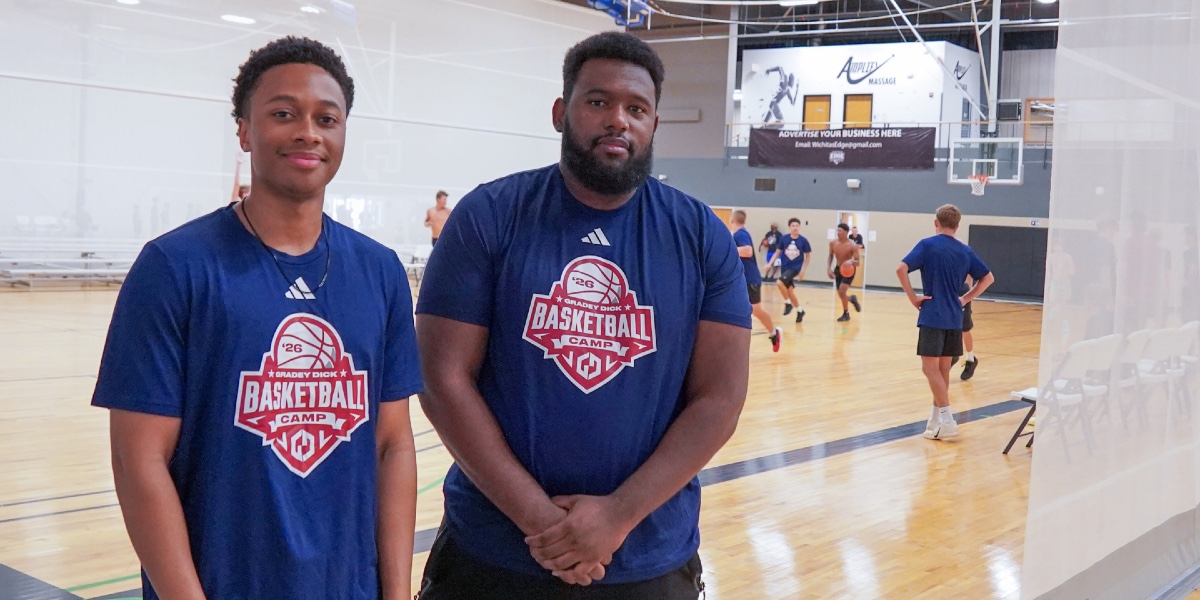 Second-year KansasCOM students Myles Davis and Xavier Daudier monitor for injuries at the Gradey Dick Youth Basketball Camp.
